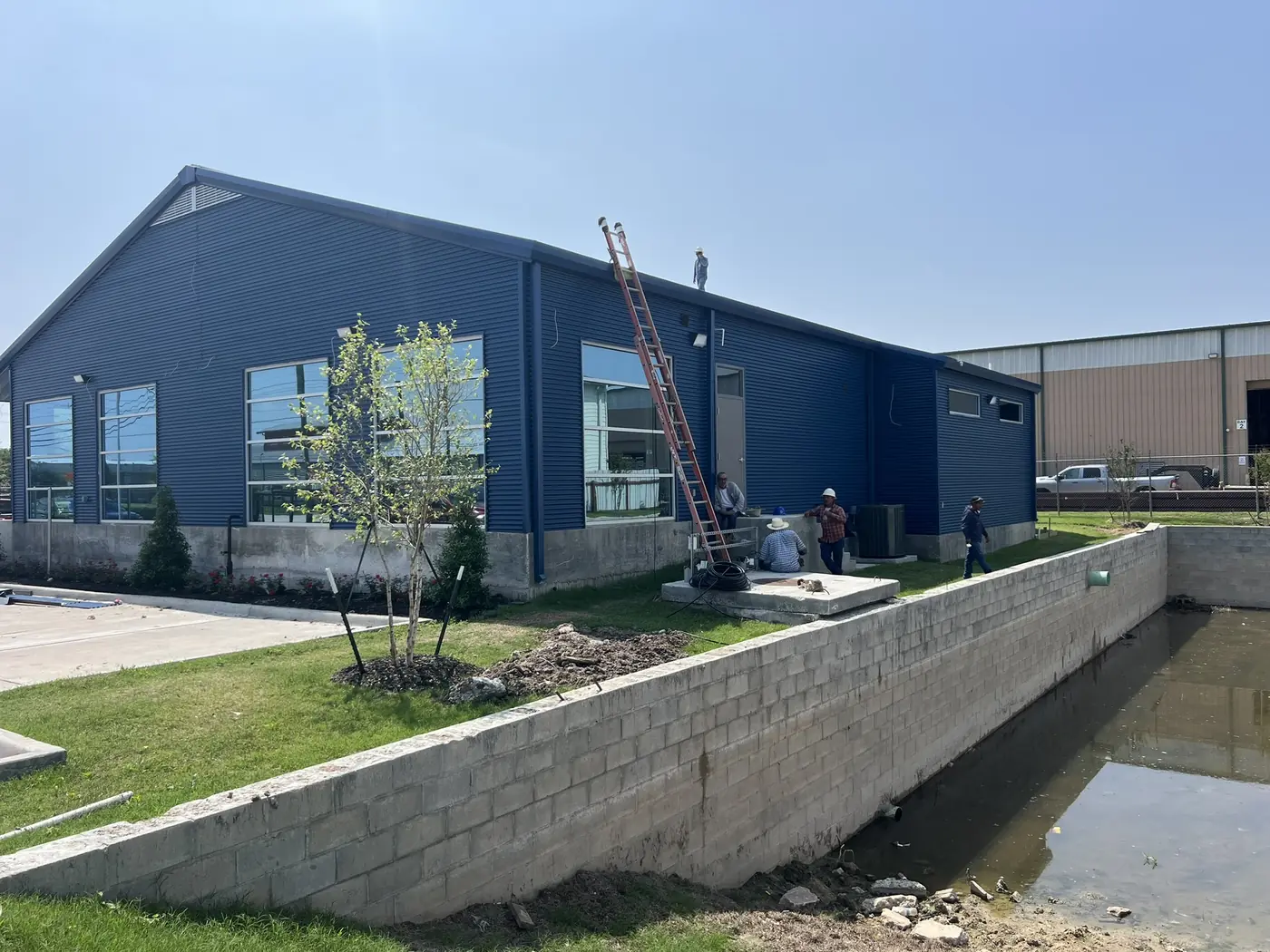Completed blue industrial building with landscaped frontage