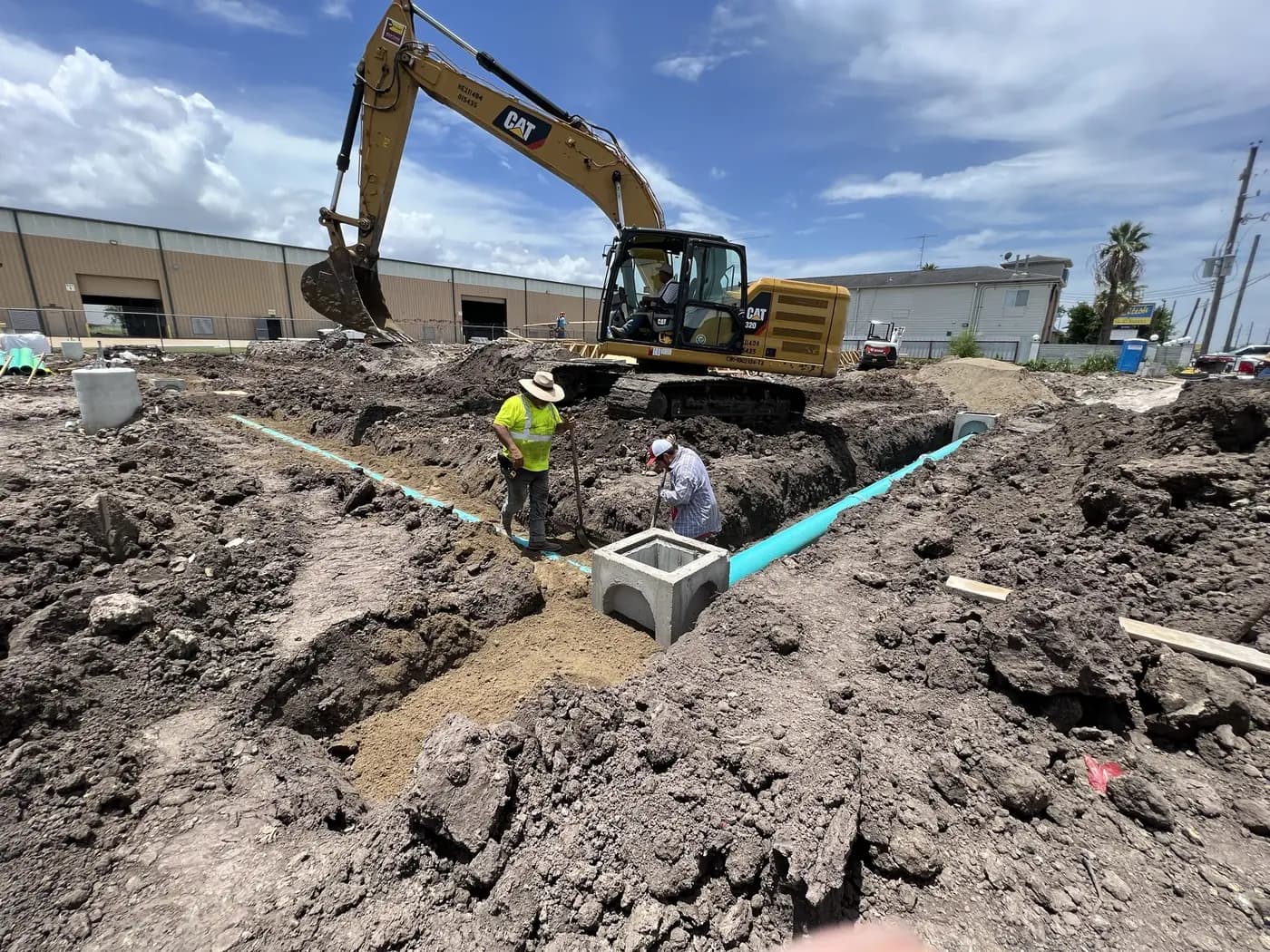 Excavator working around newly installed underground piping