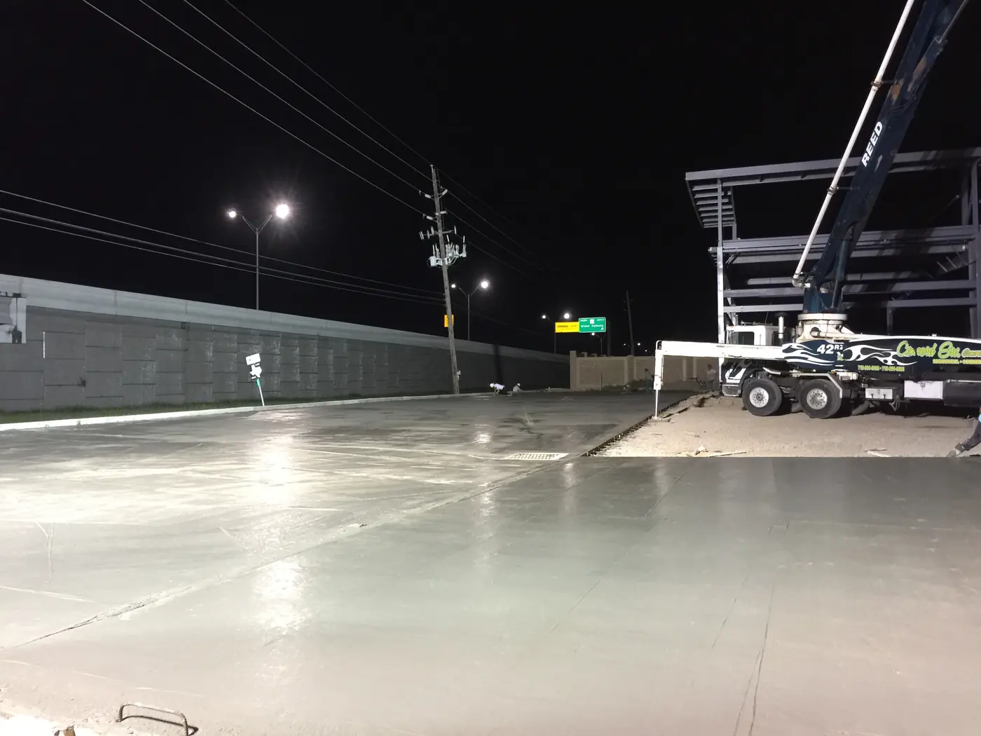 Freshly finished concrete slab illuminated during nighttime work