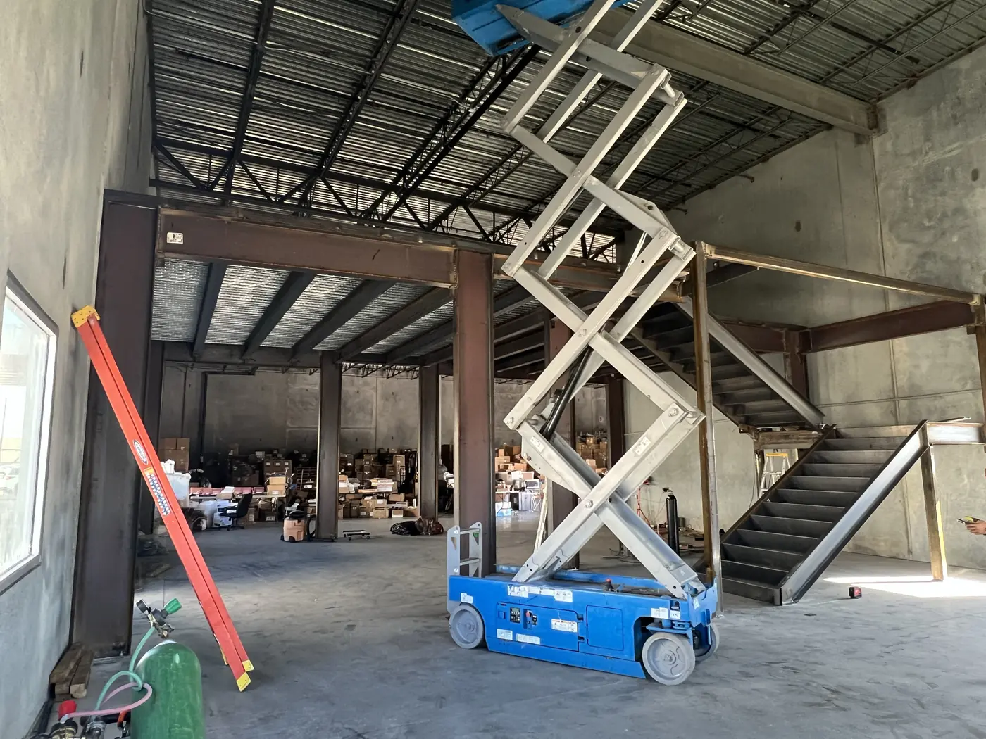 Scissor lift positioned for interior structural steel installation