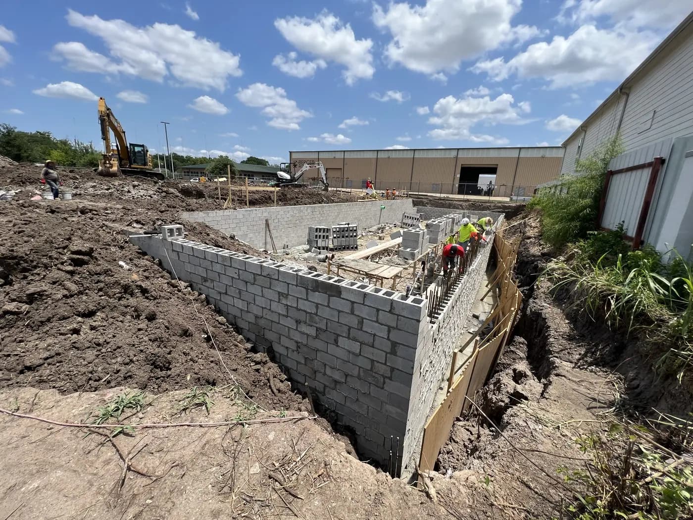 Concrete masonry retaining wall beside an active excavation