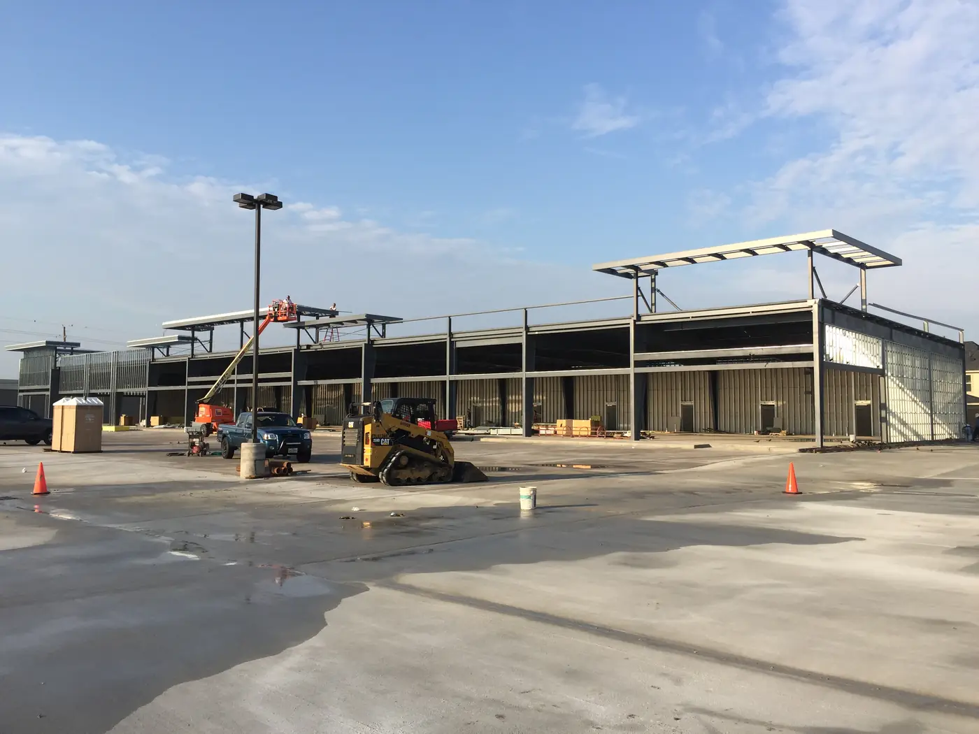 Steel-framed commercial building surrounded by active paving work