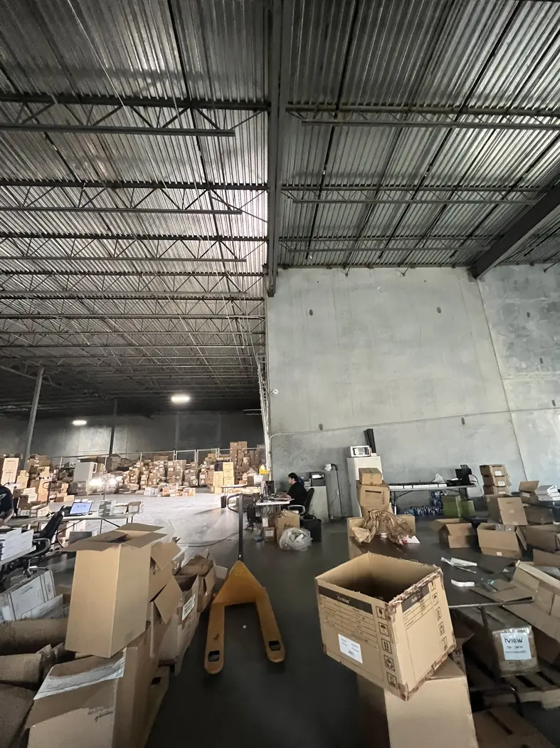 Warehouse interior showing the structural roof grid and operating equipment