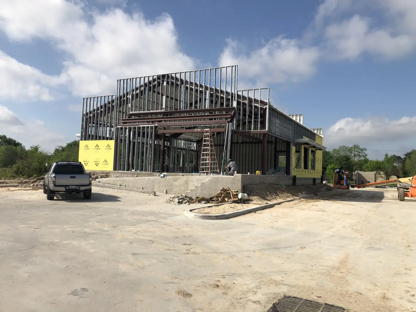 Clinic building under construction with structural framing and exterior sheathing