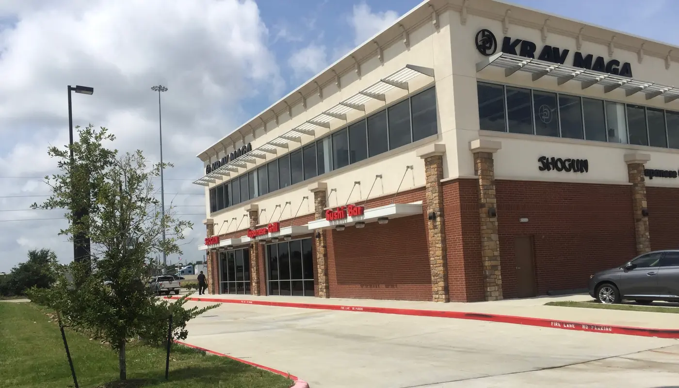 Completed two-story retail center with brick, stone, and glazed storefronts